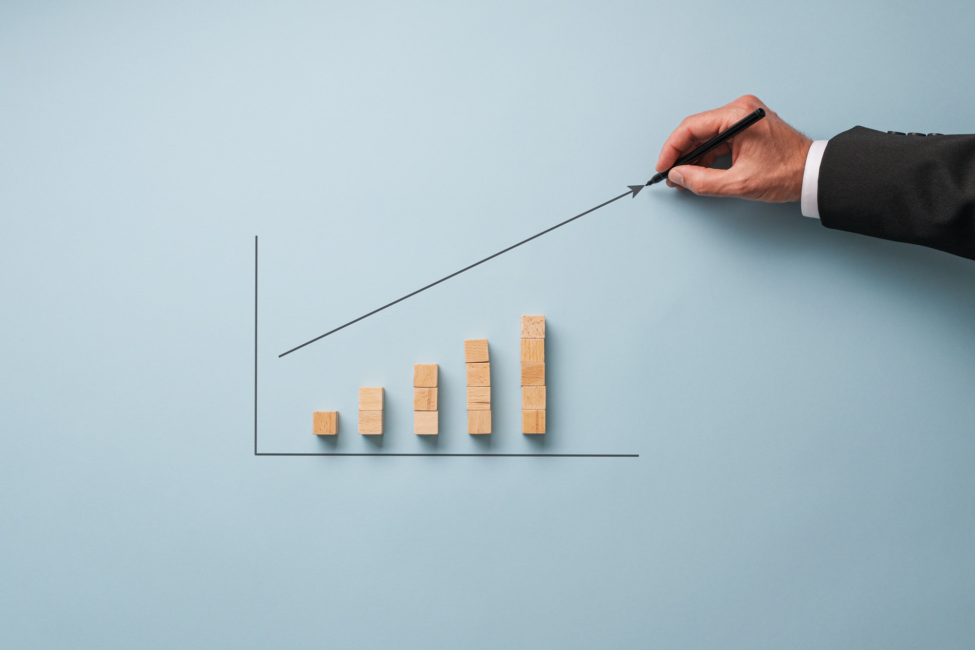 Businessman drawing financial graph