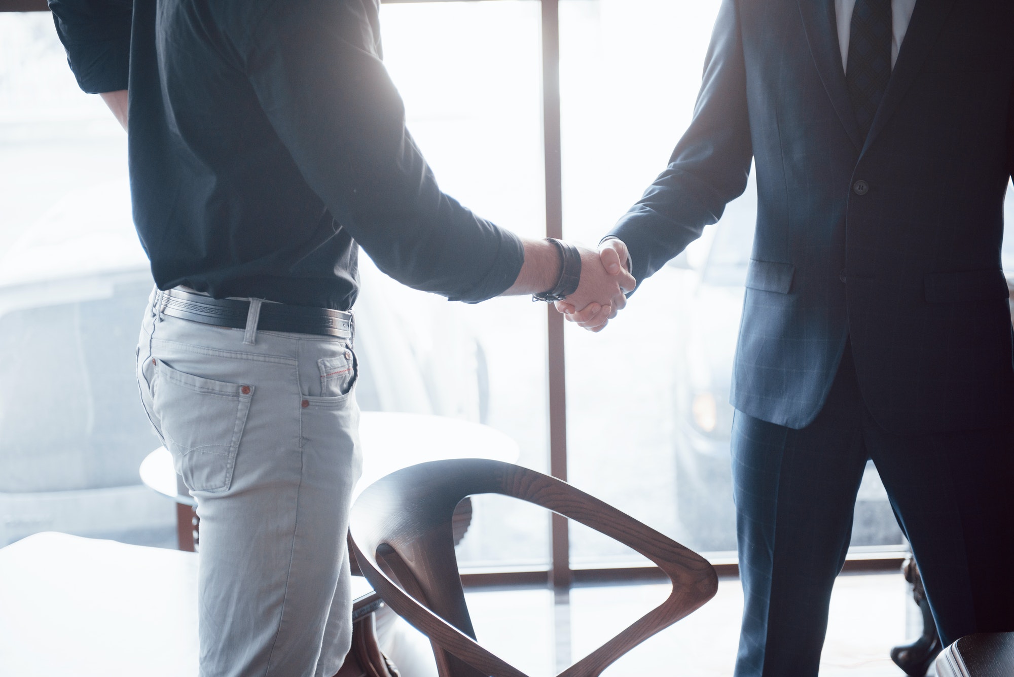 Two confident business man shaking hands during a meeting in the office